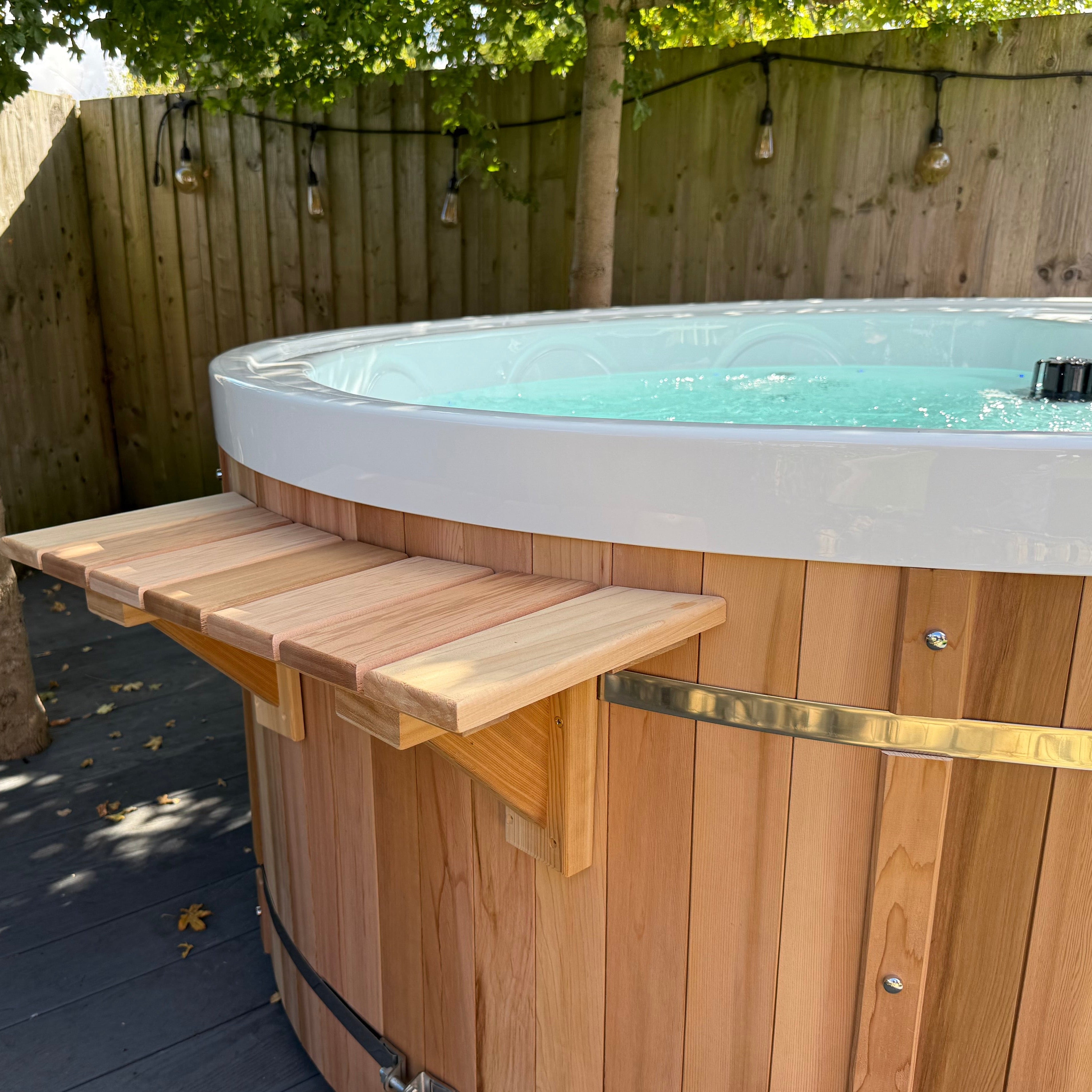 Wooden hot tub with a wooden deck on a patio